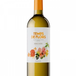 Copa de vino blanco Temps de Flors Sumarroca rodeada de flores.